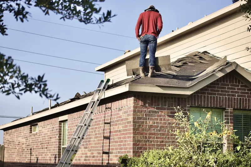 Professional roofer working on a residential roof in Loys Corners